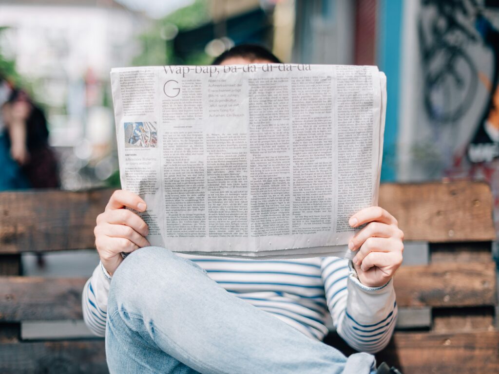 person holding a newspaper