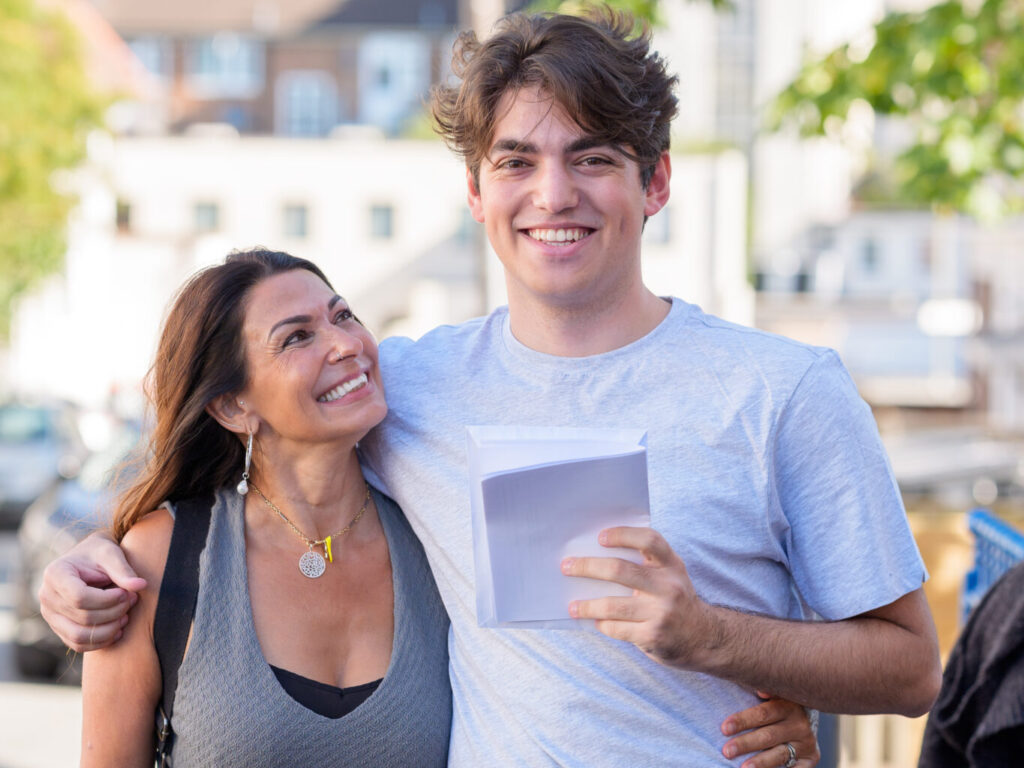 student holding his exam results