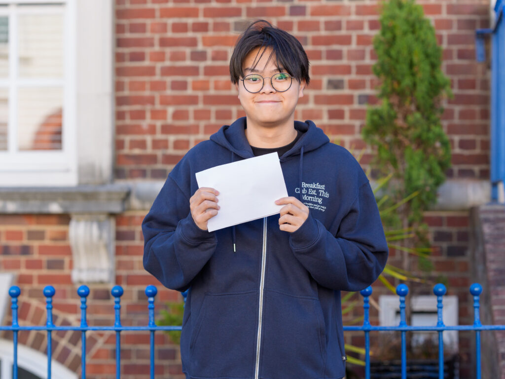 student holding his exam results