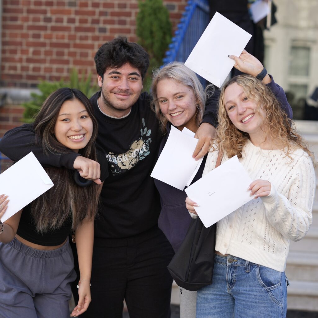 students holding their results